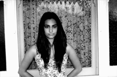 Photography by Alara Baldwin, Alexandra Phillips, Chelsea Hillas, Emily Kalafatis, Furat Alsabti, Gabbie Cirillo, Georgie Evans, Lauren Minicozzi, Margot Craig, Melanie Nixon, Mikaela Cowan, Natalie Sakarintr, Paul Prato, Rebecca Brun and Sarah Mitchell, Year 10, Goulburn Valley Grammar School Student photograph of a girl standing with her hands behind her back